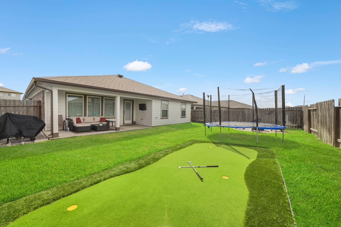 8210 Buck Lane Rosharon, TX 77583 - Photo 29 of 30 Spacious backyard featuring a putting green and plenty of room for recreation.
