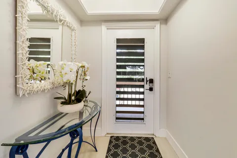 a view of a bedroom with a table and a chair
