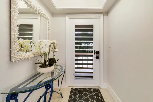 a view of a bedroom with a table and a chair