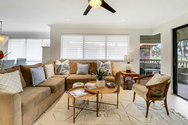 a living room with furniture kitchen view and a flat screen tv