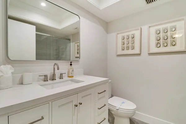 a bathroom with a sink vanity and a mirror
