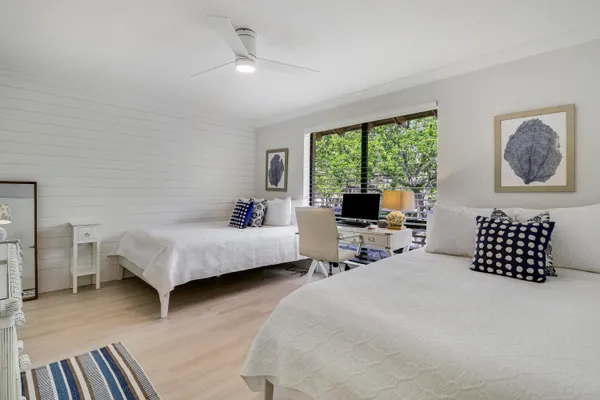 a bathroom with double vanity sink and two mirror