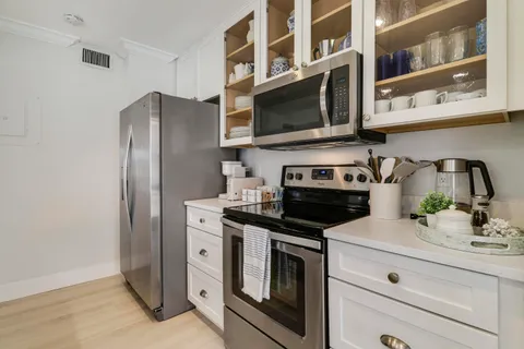a kitchen with stainless steel appliances a sink and cabinets