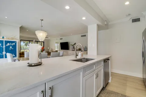 a view of a dining room with furniture and a chandelier