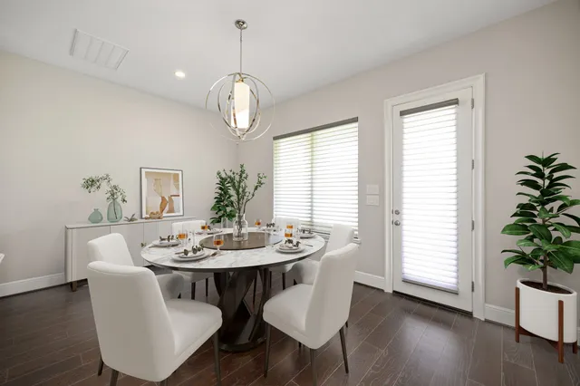 a view of a dining room with furniture wooden floor and chandelier