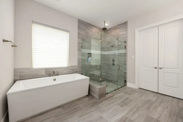 a bathroom with a bathtub and shower