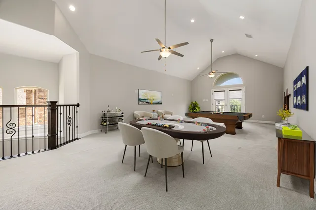 a view of a dining room with furniture and a chandelier