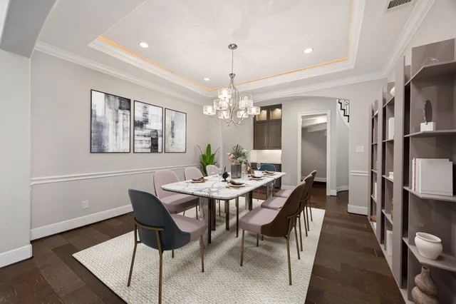 a view of a dining room with furniture and chandelier