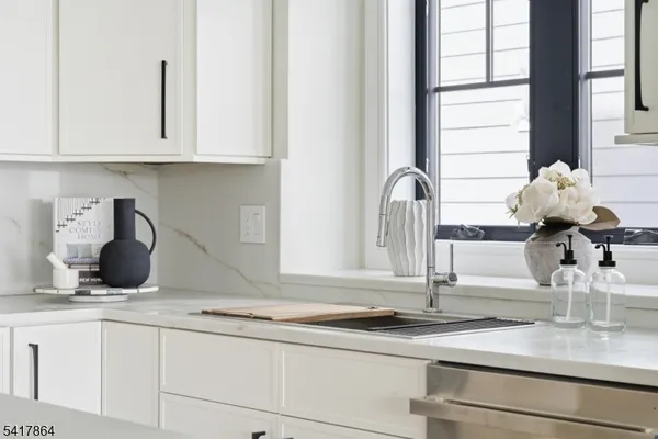 a kitchen with a sink cabinets and appliances
