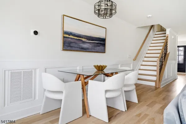 a living room with stainless steel appliances kitchen island granite countertop furniture and a wooden floor