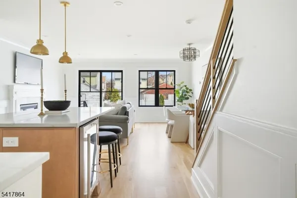 a kitchen with stainless steel appliances granite countertop a stove and white cabinets