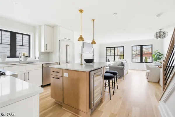 a kitchen with stainless steel appliances granite countertop a sink stove and cabinets