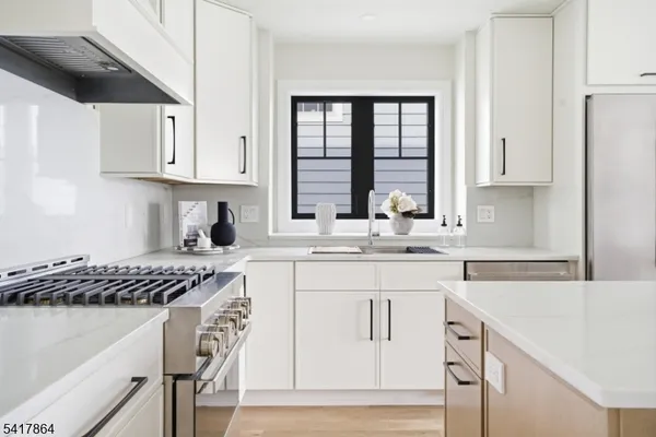 a kitchen with a stove and a white cabinets