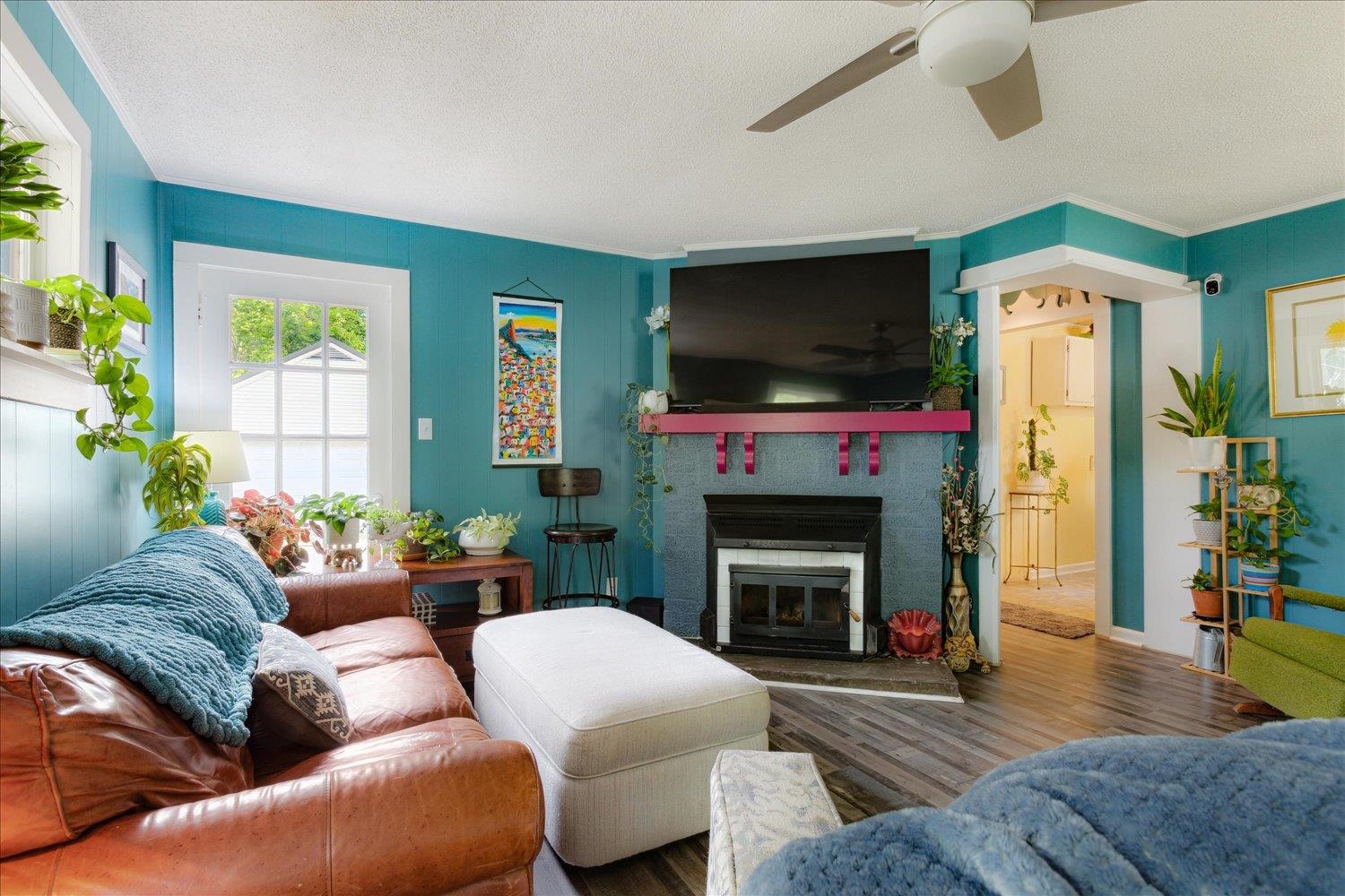 3707 Whittier Road Memphis, TN 38108 - Photo 6 of 35 a living room with furniture a flat screen tv and a fireplace