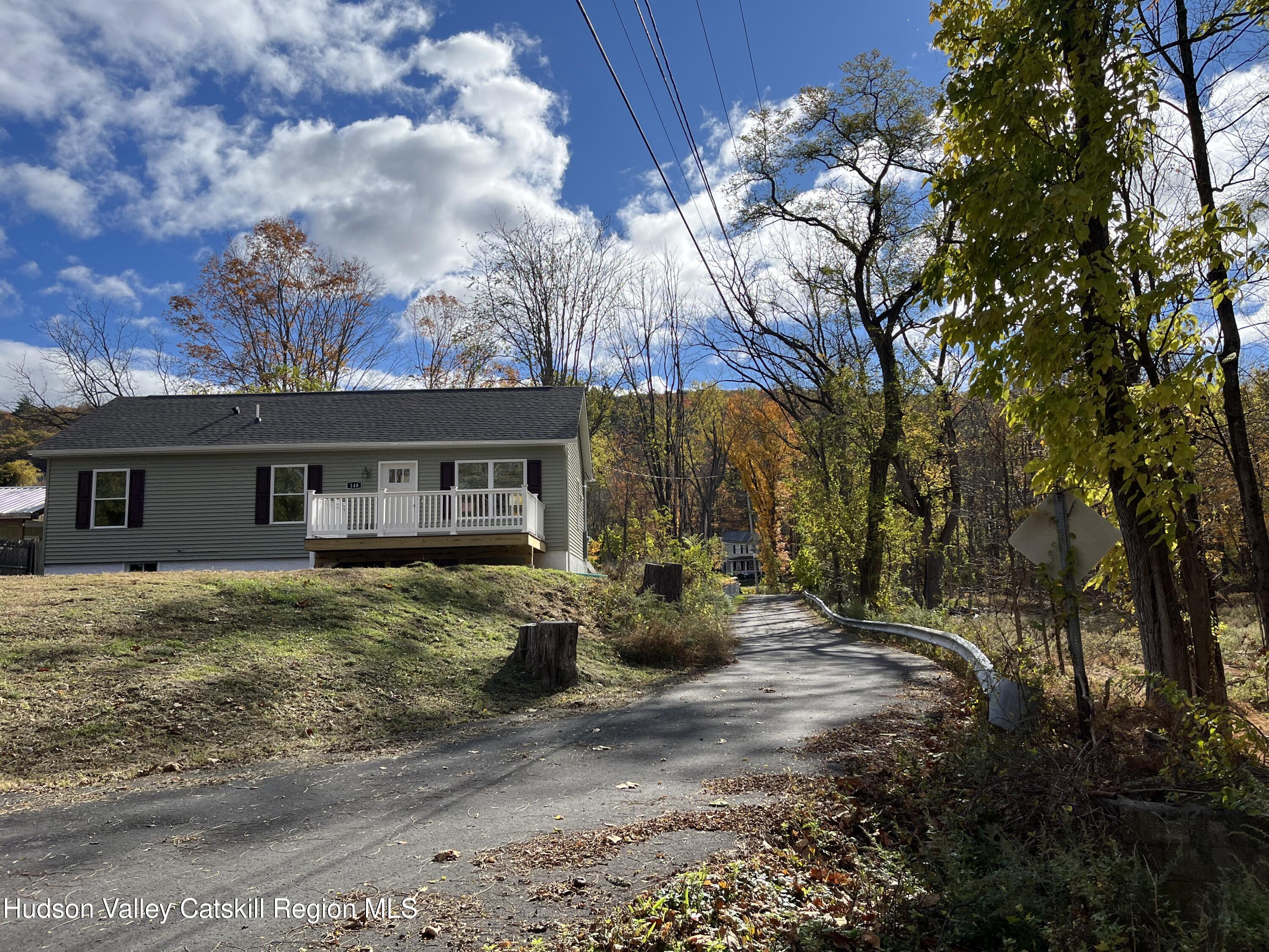 a front view of house with yard space and seating