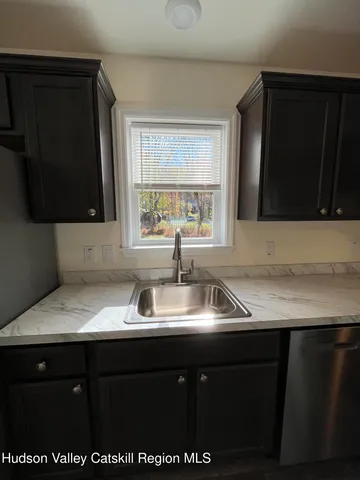 a kitchen with a sink a stove and microwave