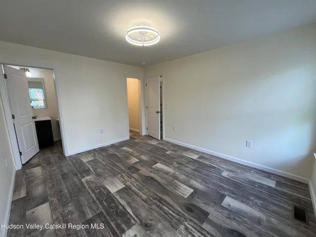 a view of a room with wooden floor and bedroom