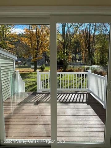 a view of a porch with wooden floor