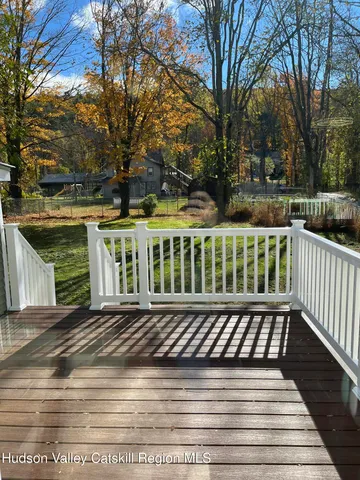 a view of a wooden deck with trees