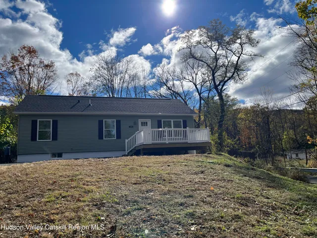 a house that has a tree in front of it