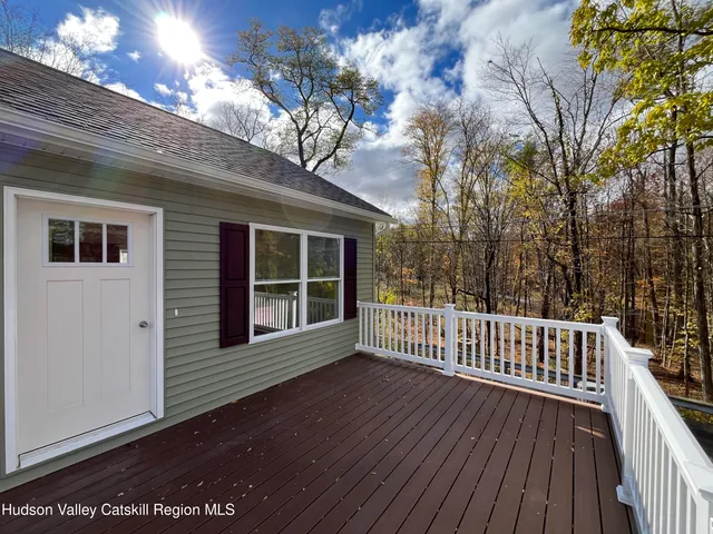 a view of backyard with a deck and wooden floor