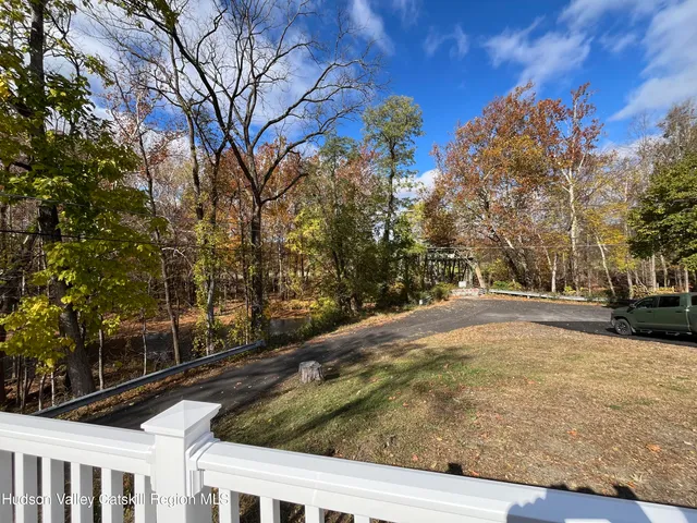 a view of a yard with plants and trees