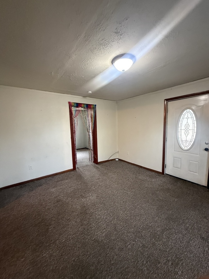 312 East 11th Street Georgetown, IL 61846 - Photo 2 of 25 a view of an empty room with a window