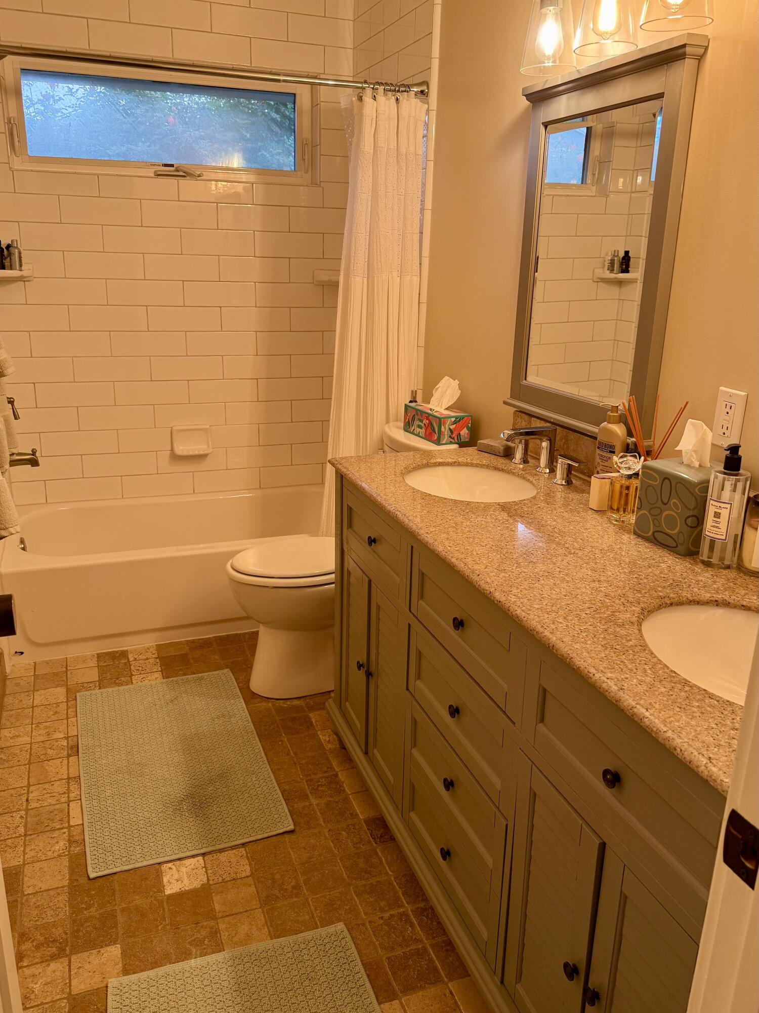 1353 Pacific Santa Barbara, CA 93109 - Photo 13 of 14 a bathroom with a double vanity sink toilet and a mirror