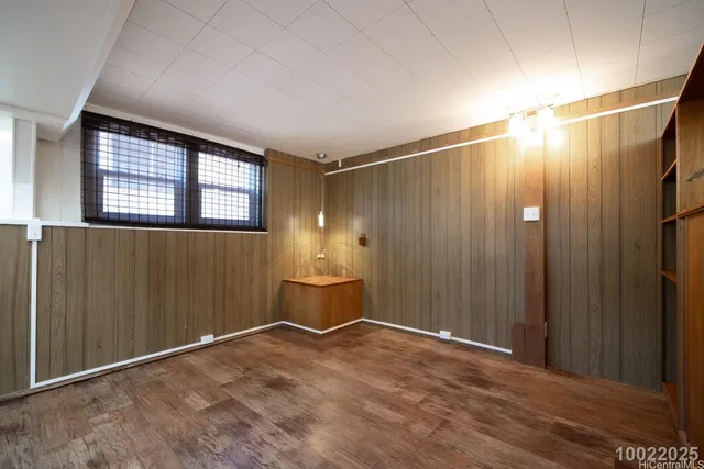 a view of a livingroom with wooden floor and furniture