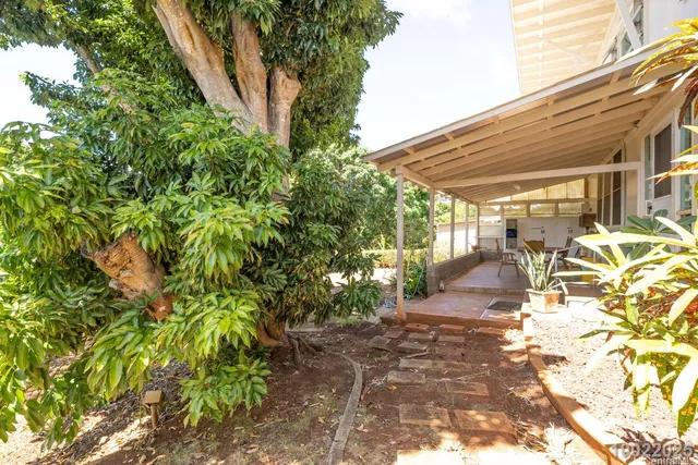 a view of a patio with table and chairs and potted plants