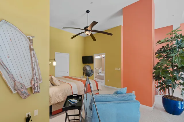 a bedroom with a bed and a painting on the wall