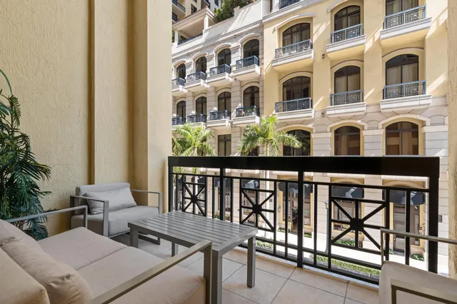 a view of tall buildings and cars parked