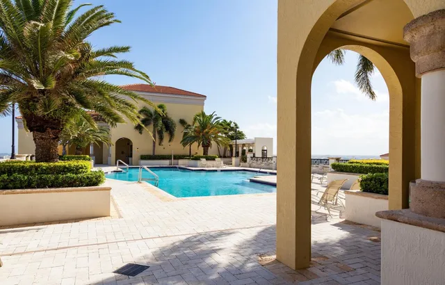a swimming pool with outdoor seating and yard