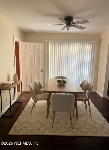 a view of a dining room with furniture and wooden floor