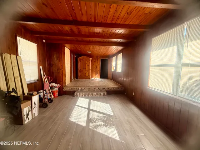 a view of outdoor space with wooden floor and windows