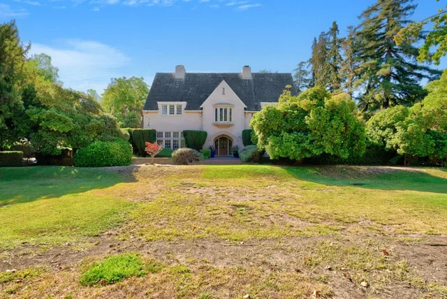 a front view of a house with garden