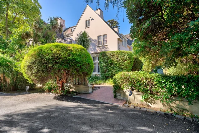 a front view of a house with outdoor seating and a potted plant