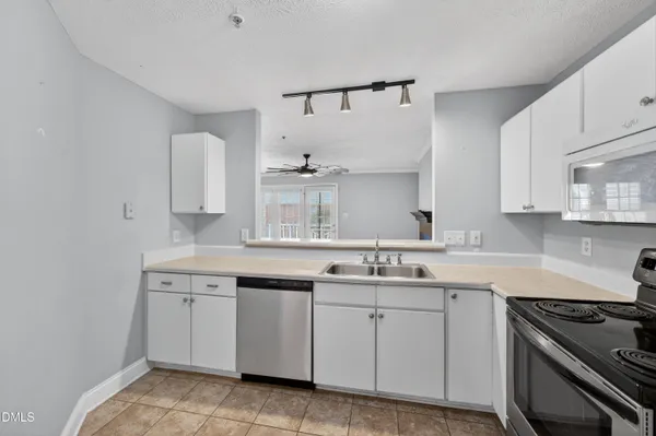 a kitchen with a sink stove and refrigerator