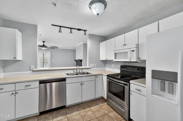 a kitchen with cabinets stainless steel appliances and a sink