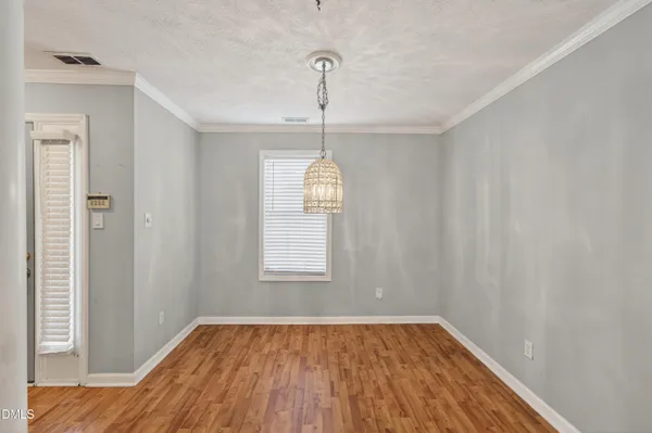 a view of livingroom with hardwood floor and kitchen view