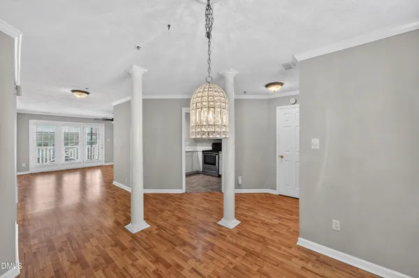 a kitchen with white cabinets and appliances