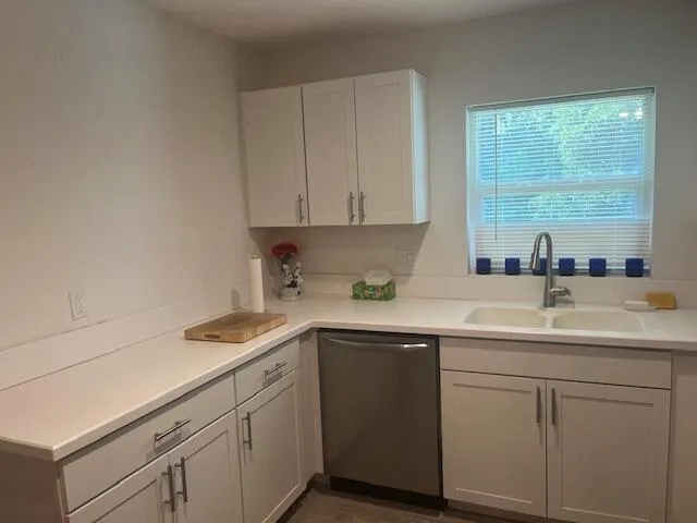 a kitchen with a sink cabinets and window