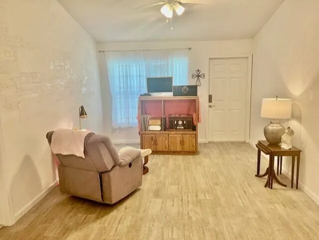 a living room with furniture and a wooden floor