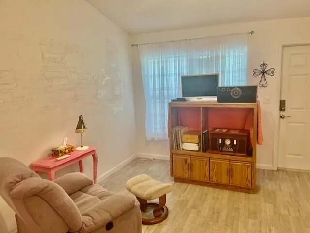 a bedroom with furniture and a wooden floor