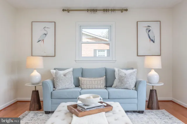 a living room with furniture and a lamp