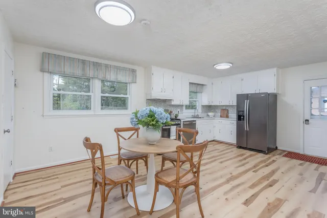 a dining room with furniture and window