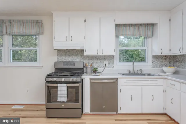 a kitchen with appliances cabinets and a window