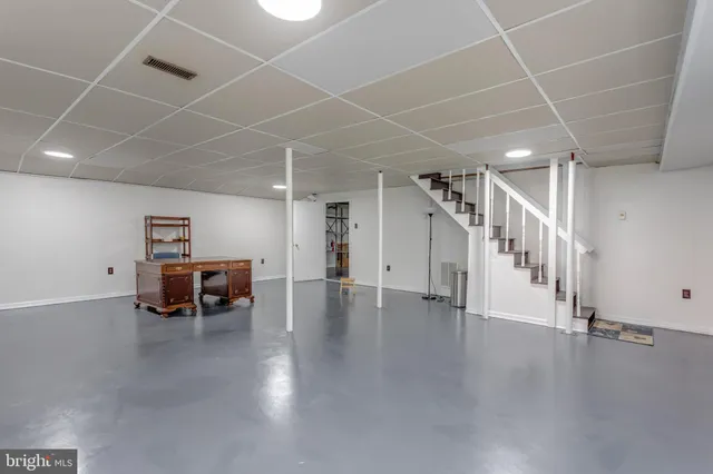 a view of a livingroom with wooden floor and a barbeque grill