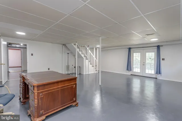 a kitchen with stainless steel appliances a stove a sink and white cabinets with wooden floor