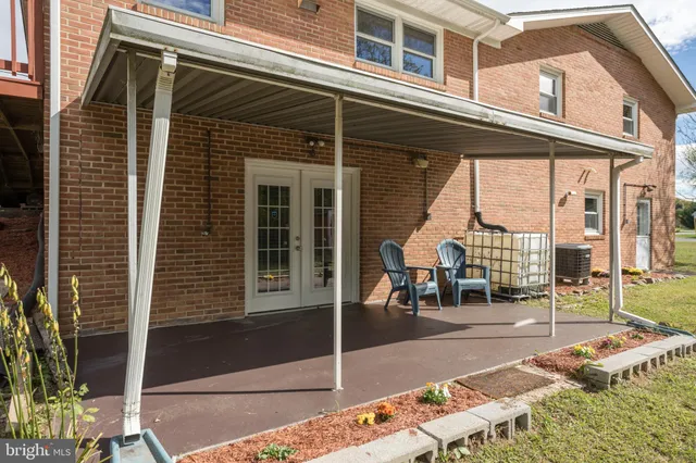 a backyard of a house with table and chairs